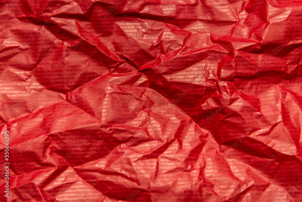 Red crumpled packaging paper textured background Red crumpled packaging paper textured background