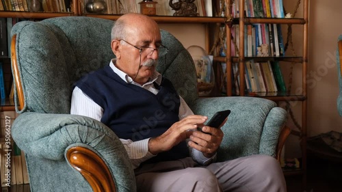 senior man using smart phone for communicate and make video chat with his children 
