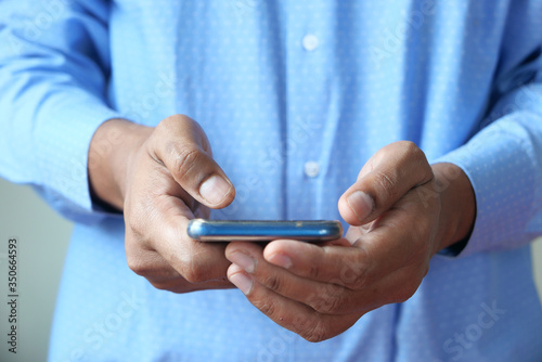 Close up of a man using mobile smart phone.