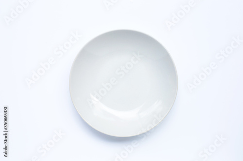 Empty white ceramic plate on white background.