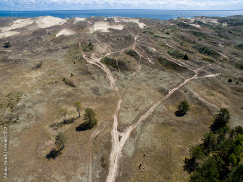 Aerial view with dunes, forest and sea in Curonian spit on a sunny day photographed with a drone. The Curonian Spit lagoon. Gray Dunes, Dead Dunes. 
