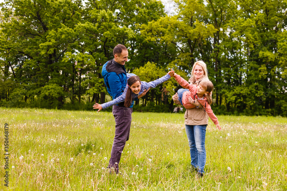 young familiy are walking through a green field young familiy are walking through a green field