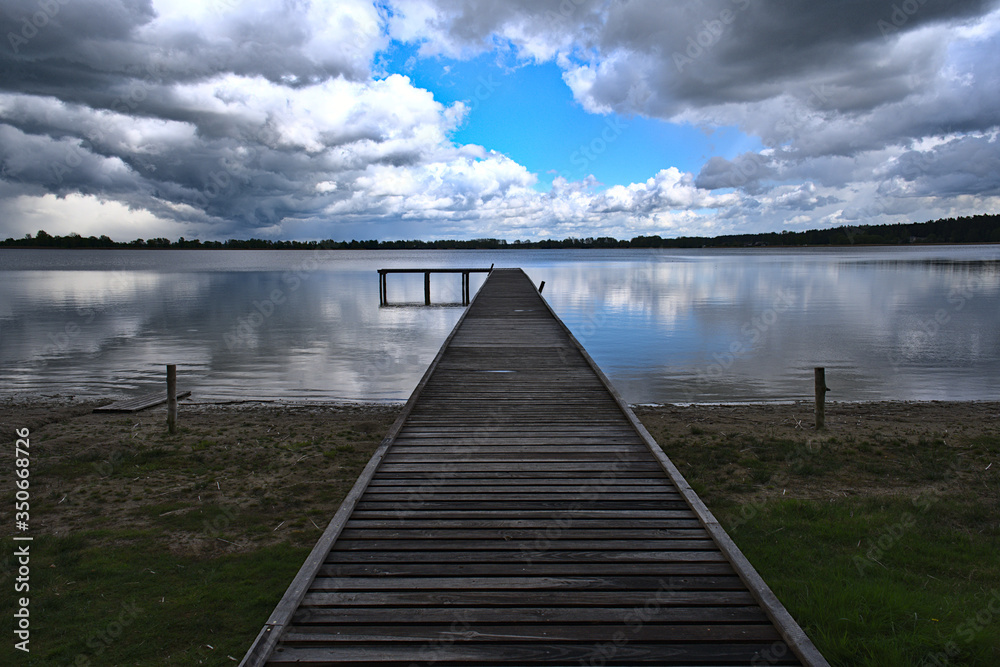 Naklejka premium wooden bridge over lake