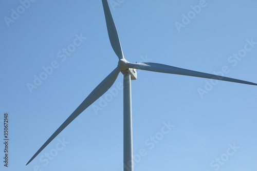 Windmill for electric power production, France. Blue sky
