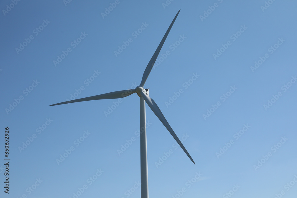 Windmill for electric power production, France. Blue sky Windmill for electric power production, France. Blue sky