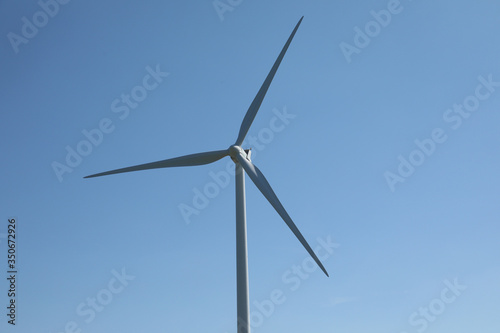 Windmill for electric power production, France. Blue sky © robin-clouet.fr