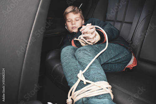 the captive child in the car. Illegal theft and ransom of a child Fototapeta