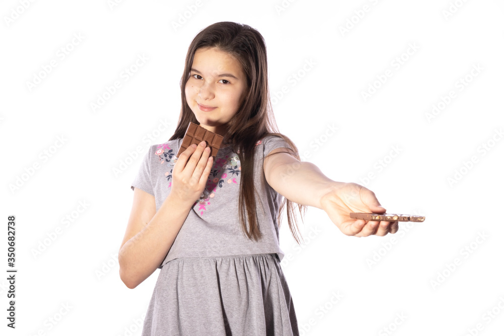 girl with black hair holds a bar of chocolate in her hands and holds out a second bar girl with black hair holds a bar of chocolate in her hands and holds out a second bar