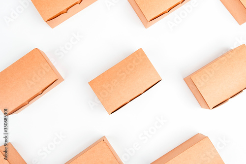 Eco boxes for food delivery on a white background are laid out in a pattern