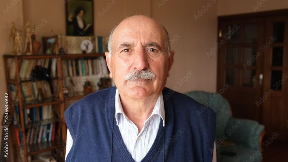 Portrait of bald senior man looking in to the camera with poker face at home 4K Portrait of bald senior man looking in to the camera with poker face at home 4K
