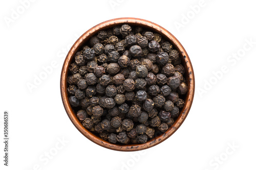 Fototapeta Naklejka Na Ścianę i Meble -  Black pepper grains spice in wooden bowl, isolated on white background. Seasoning top view