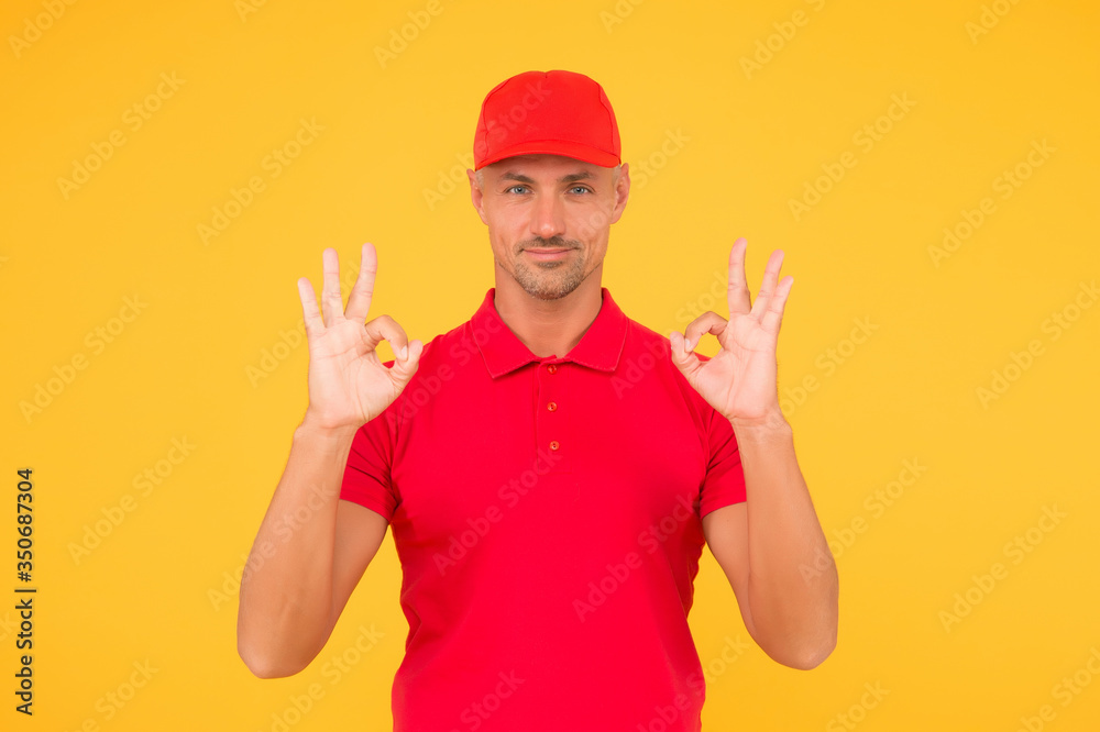 Everything will be OK. Happy guy show okay signs. Guy with ring gestures yellow background. Handsome guy in casual style. Unshaven guy wear red cap and polo shirt. Fashion and style. Menswear store Everything will be OK. Happy guy show okay signs. Guy with ring gestures yellow background. Handsome guy in casual style. Unshaven guy wear red cap and polo shirt. Fashion and style. Menswear store