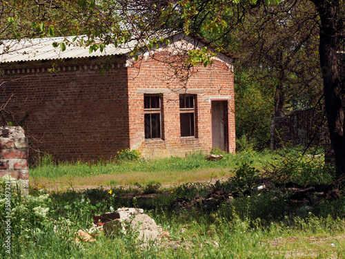 Abandoned brick building on a summer day. An abandoned old brick building in a dilapidated state