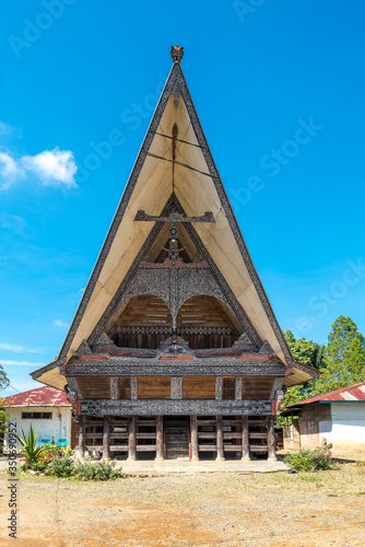 Traditional Batak house, in Indonesian called Rumah Bolon or Jabu, are noted for their distinctive roofs which curve upwards at each end, as a boats hull does and their carving decor