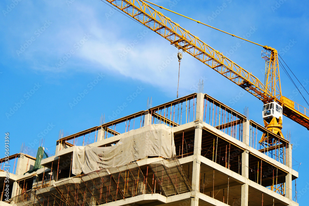 Tower crane and building activity. Construction site background. Tower crane and building activity. Construction site background.