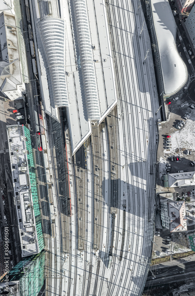 Aerial overhead view of Salzburg railway station with rails covered with snow in winter morning