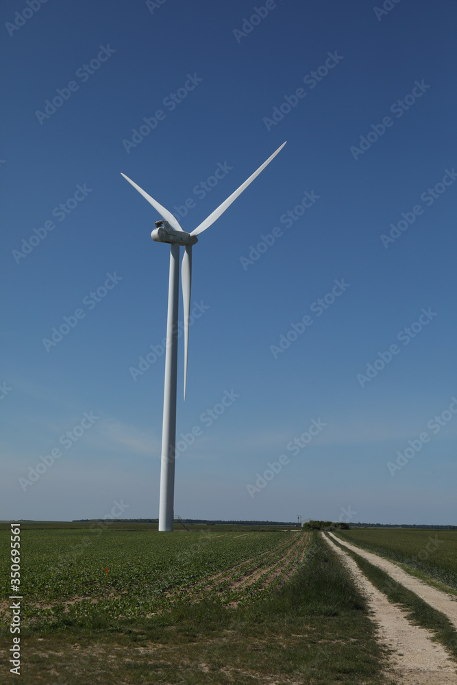 Windmill for electric power production, France. Blue sky Windmill for electric power production, France. Blue sky
