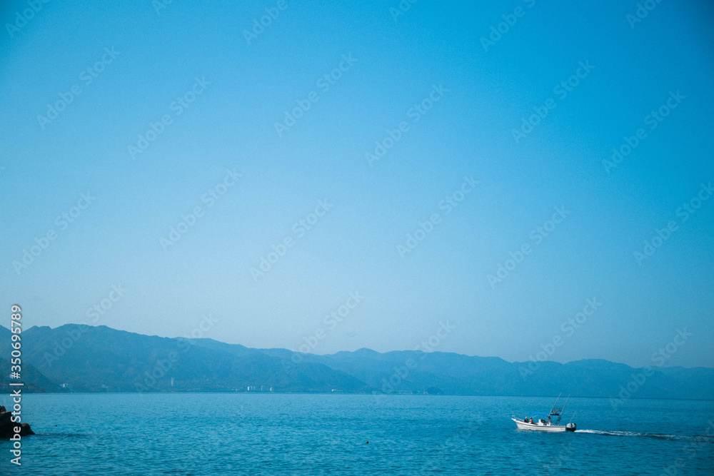 fishing boat leaving for the day to catch fish on the sea of mexico Puerto vallarta 