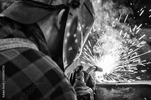Tableau sur toile Welder at work, welding iron