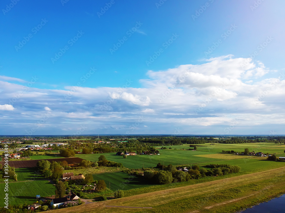 Naklejka premium White clouds on a Sunny day over the village view from a drone.
