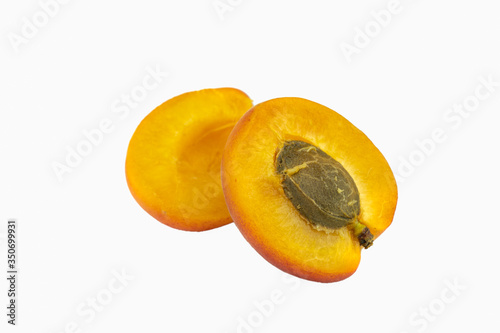 Fresh apricot isolated on white background. One sliced apricot on white