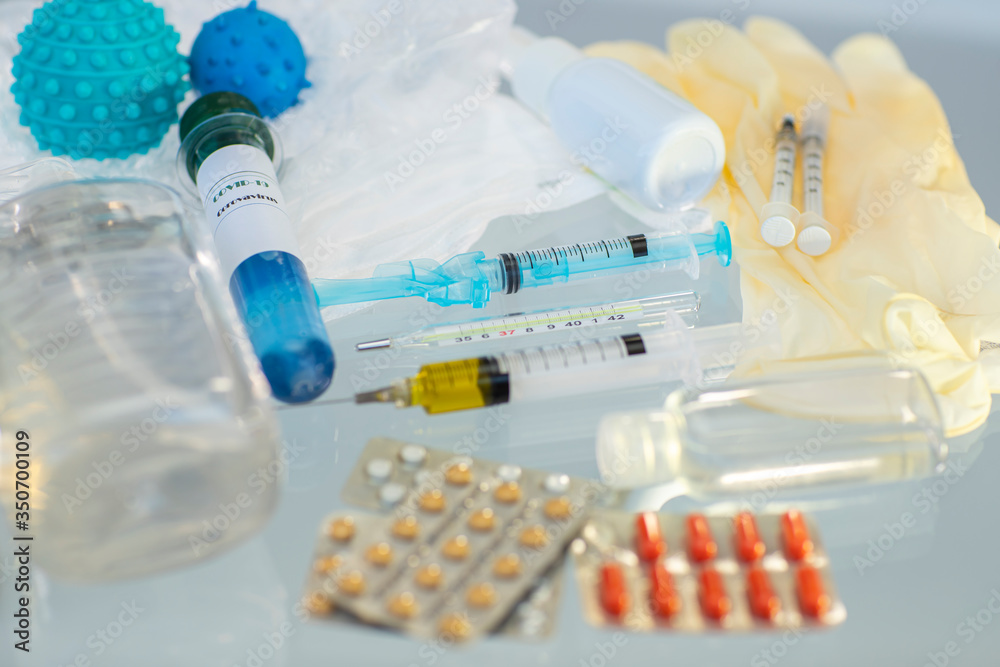 Vaccine for coronavirus. Concept of discovering a vaccine for coronavirus. Needle syringe, facemask, bottle medicine, tablets pills, thermometer, Together we protect ourself from COVID-19. Vaccine for coronavirus. Concept of discovering a vaccine for coronavirus. Needle syringe, facemask, bottle medicine, tablets pills, thermometer, Together we protect ourself from COVID-19.