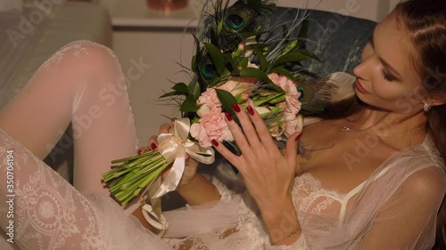 Bride in a white dress opening the window. Wedding preparations, morning bride in boudoir dressing