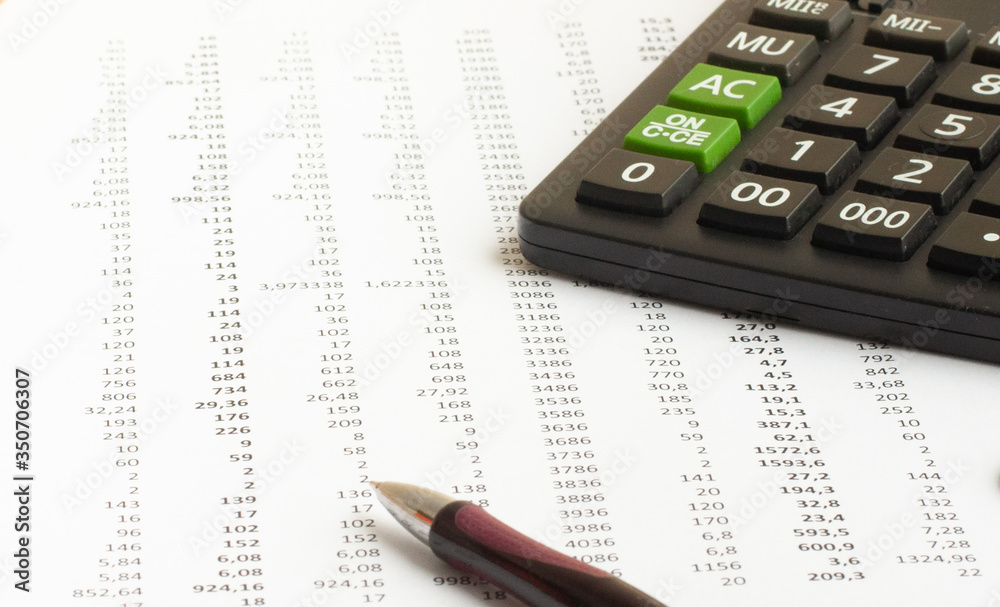 Ballpoint ink calculator and pen on a financial spreadsheet statement with columns of numbers. Ballpoint ink calculator and pen on a financial spreadsheet statement with columns of numbers.