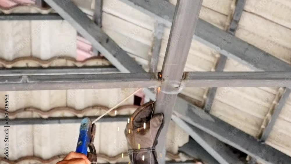 The welder is working on Welding steel at construction site. The welder is working on Welding steel at construction site.