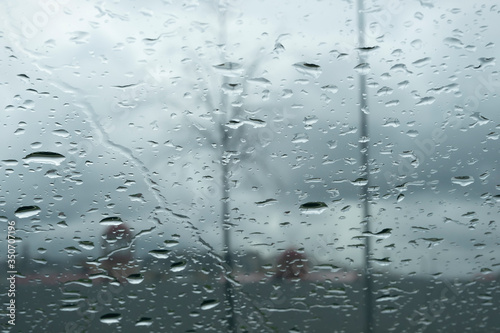 Many raindrops on a car window. Trees in the background. Background image