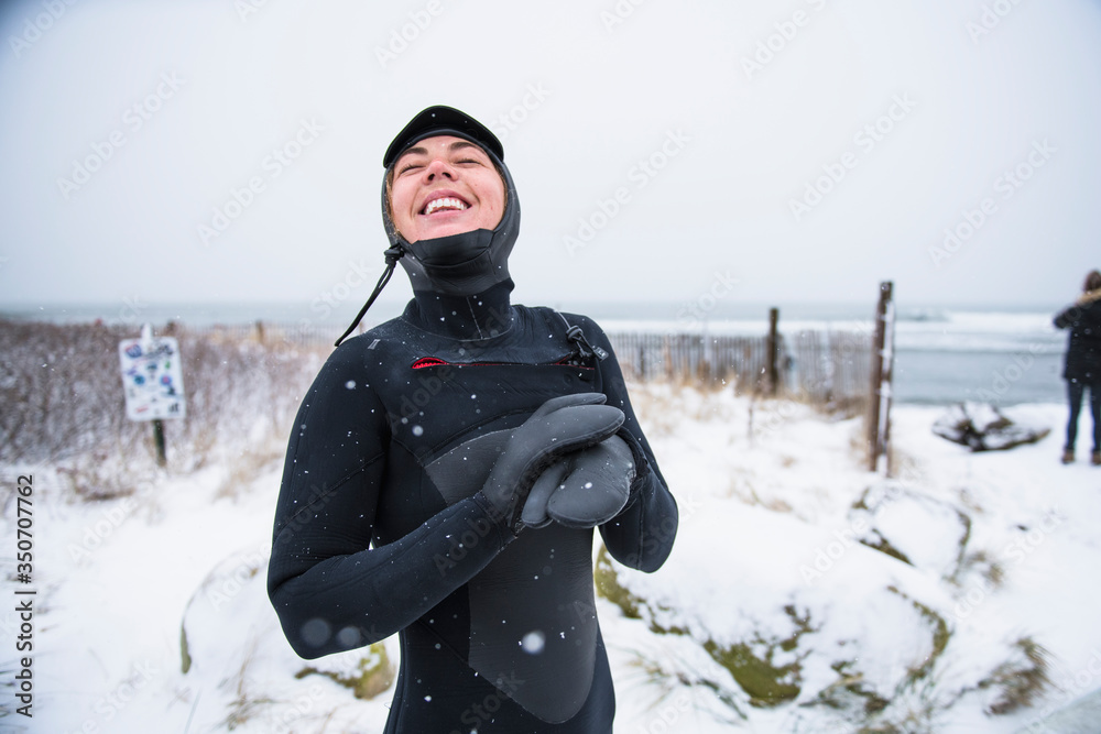 Woman going surfing during winter snow