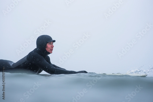 Woman surfing during winter snow