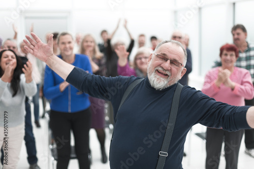 Smiling man gives a speech in meeting © ASDF