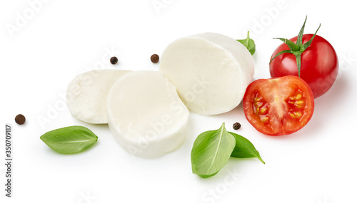 Pieces of mozzarella Buffalo cheese with tomatoes. Sliced cheese with black peppers and basil leaves isolated on white background.