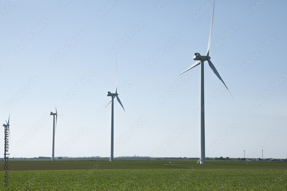 Windmill for electric power production, France. Blue sky Windmill for electric power production, France. Blue sky