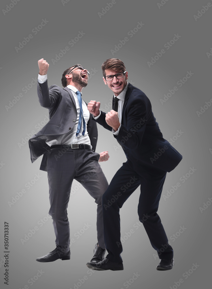 in full growth. two very happy young businessmen in full growth. two very happy young businessmen