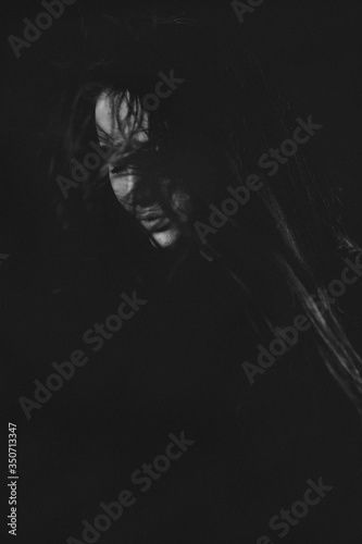 Portrait of fashion model beautiful girl playing with his long hair in studio, close up, beautiful girl young woman