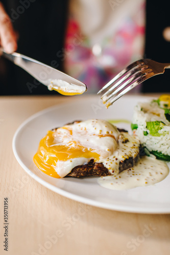 poached egg on steak with rice side dish