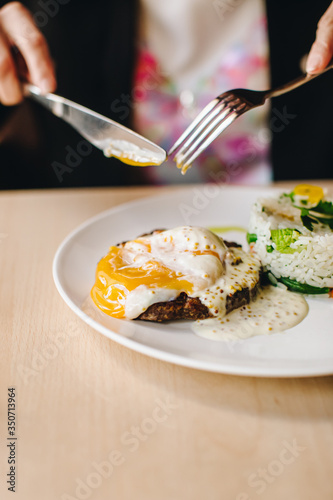 poached egg on steak with rice side dish