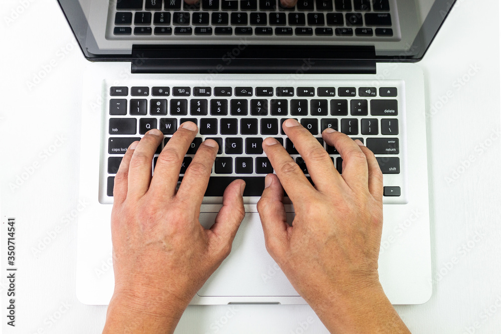 Male hands typing on a laptop