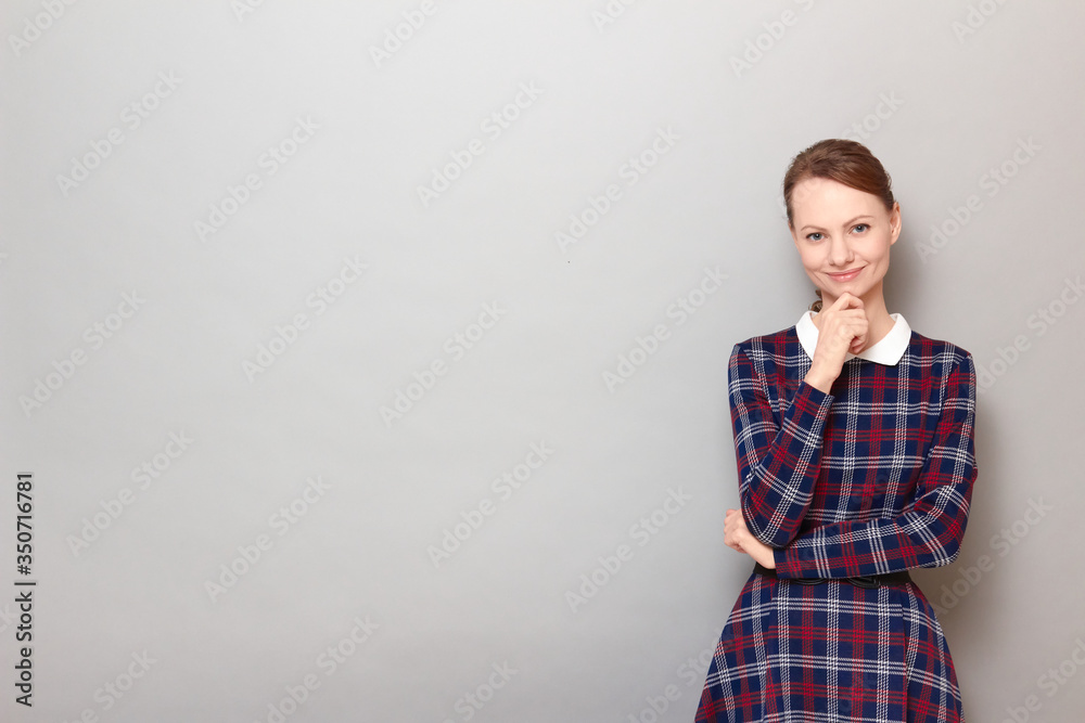 Portrait of happy girl touching chin with hand and smiling
