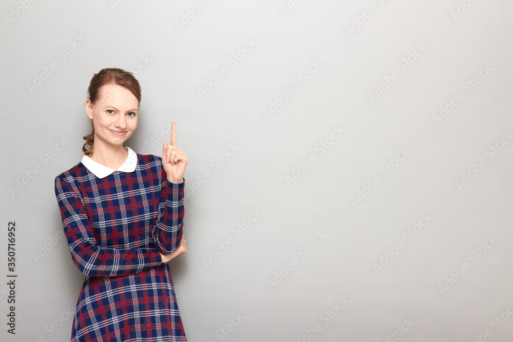 Portrait of happy girl pointing up with finger and smiling Portrait of happy girl pointing up with finger and smiling
