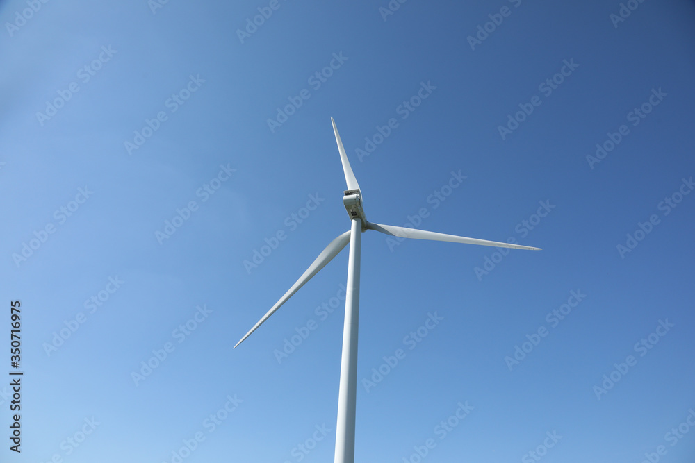 Windmill for electric power production, France. Blue sky Windmill for electric power production, France. Blue sky