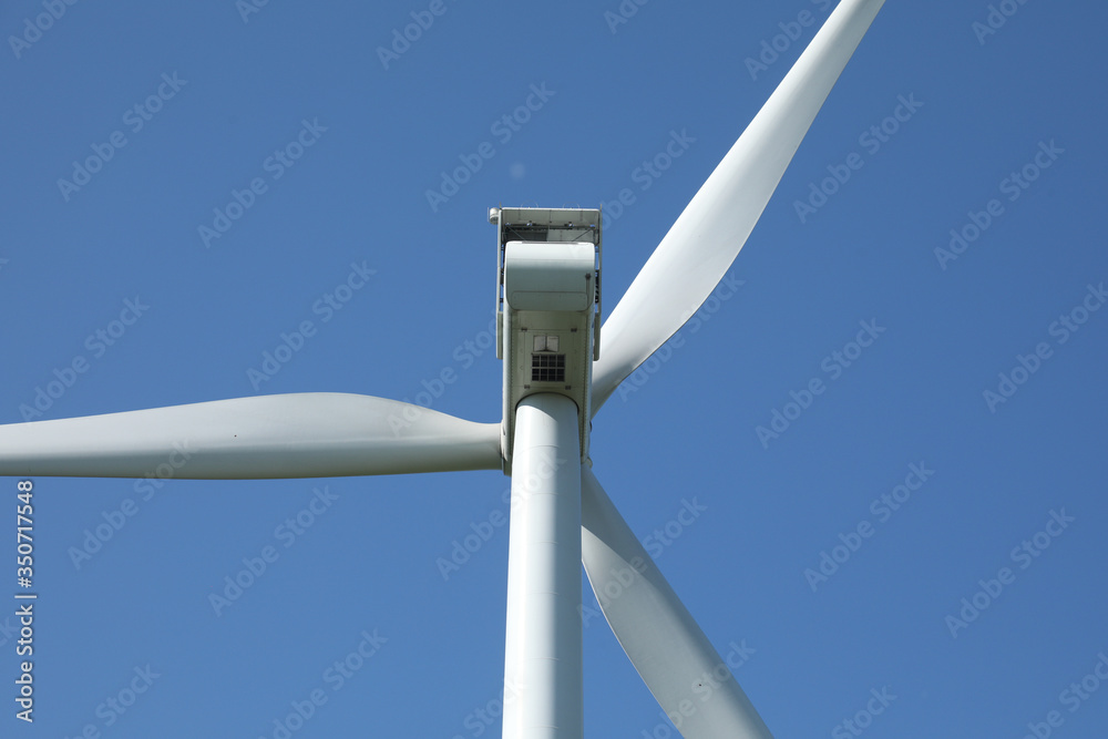 Windmill for electric power production, France. Blue sky Windmill for electric power production, France. Blue sky