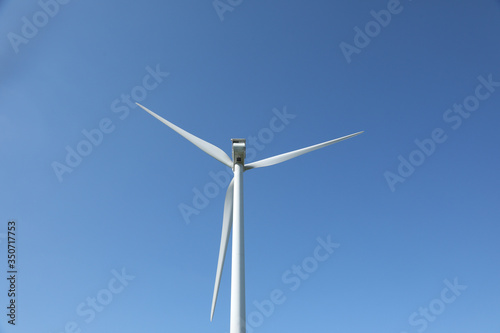 Windmill for electric power production, France. Blue sky © robin-clouet.fr