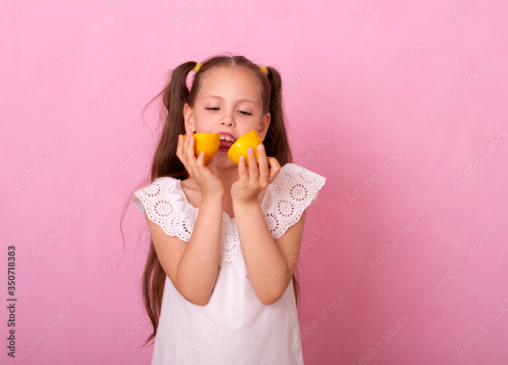 Young attractive girl posing at studio with lemon. Vitamin C Young attractive girl posing at studio with lemon. Vitamin C