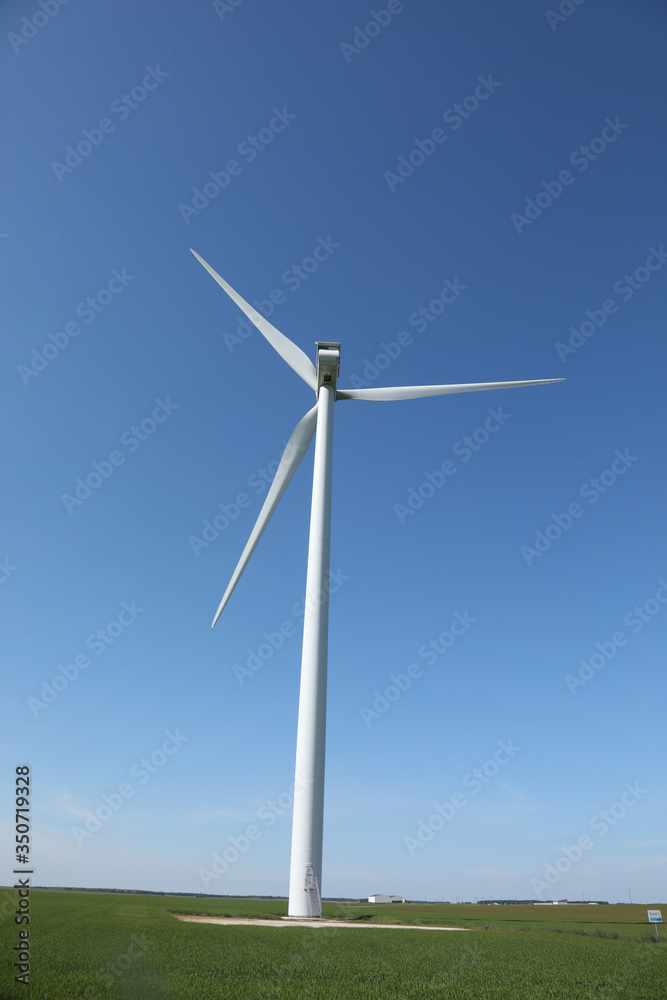 Windmill for electric power production, France. Blue sky Windmill for electric power production, France. Blue sky