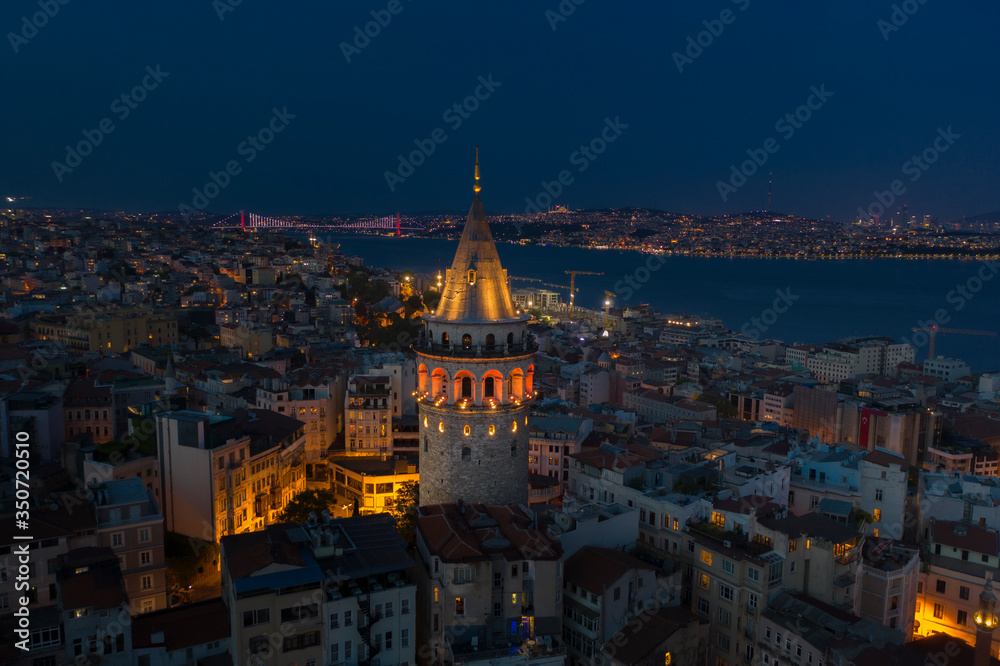 Fototapeta premium Galata Tower night aerial with Bosphorus Bridge on the background