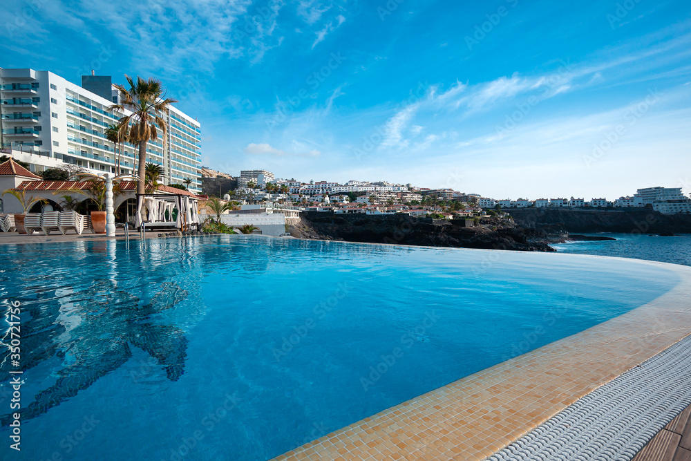 sweeming pool with typical white washed holiday rent house in Canary islands