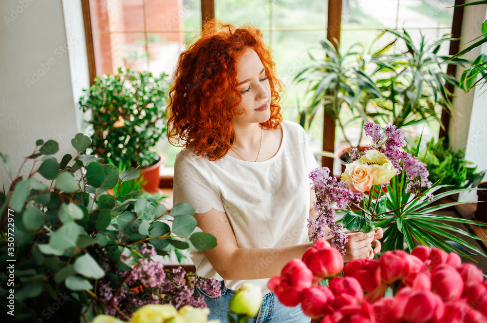Portrait of a charming red-haired girl with a bouquet in her hands Portrait of a charming red-haired girl with a bouquet in her hands